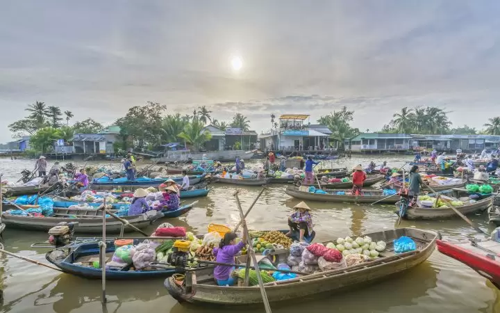 A lot of boats and sampans with diverse products gathering and trading on Cai Be floating market
